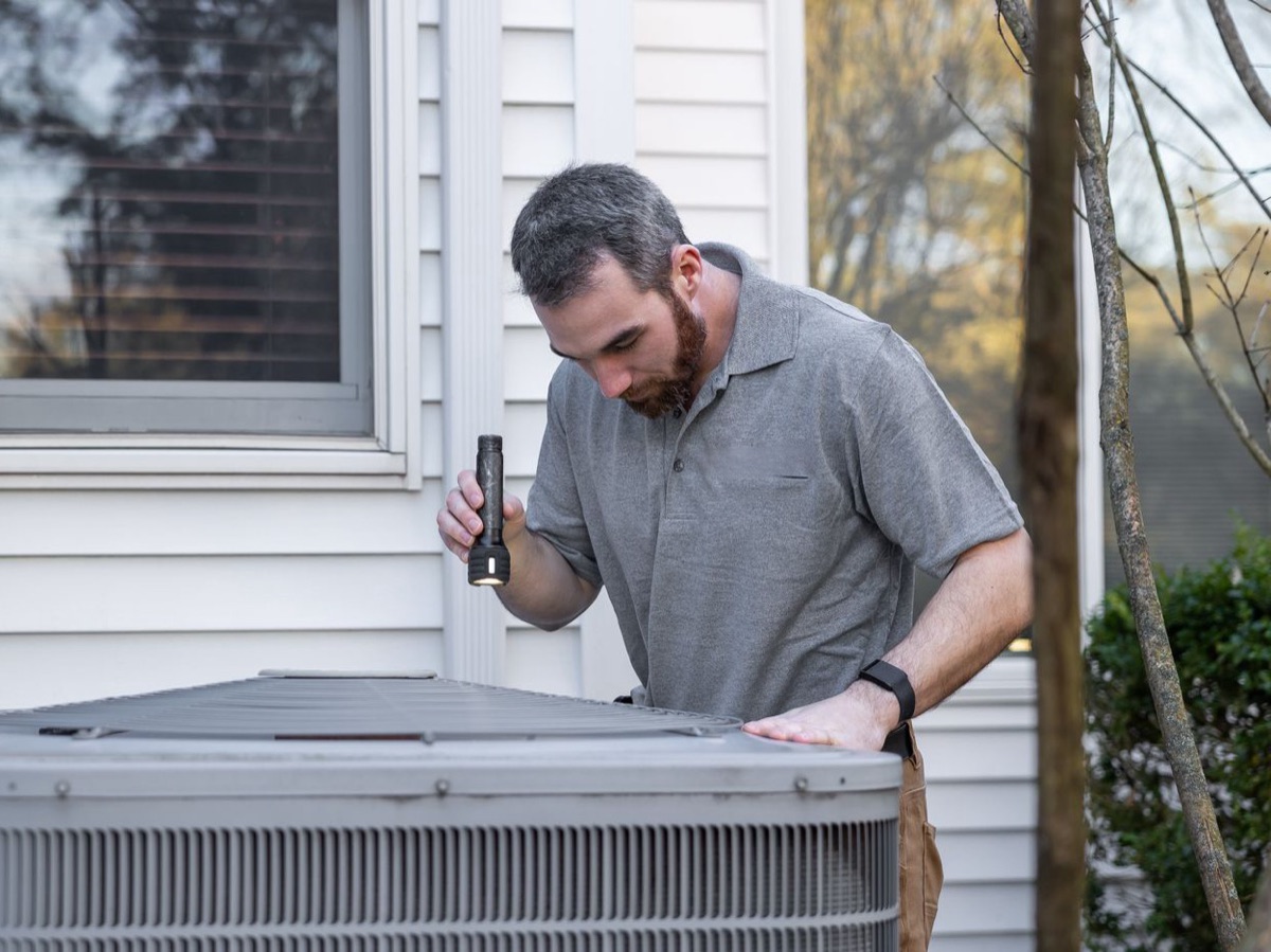 New outdoor heat pump unit installed beside a home